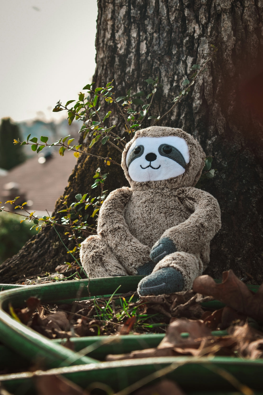 a stuffed animal is sitting in the leaves