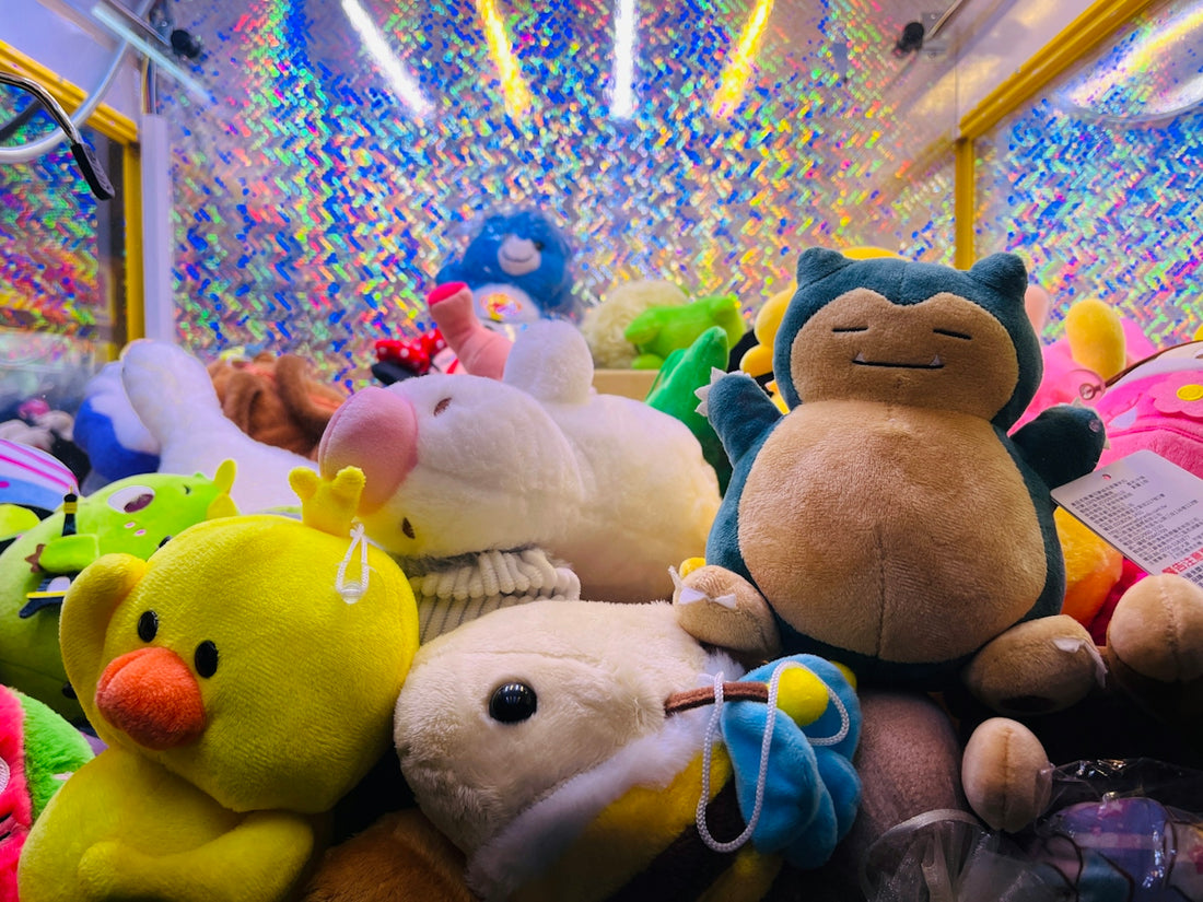 A claw machine is filled with cute plush toys