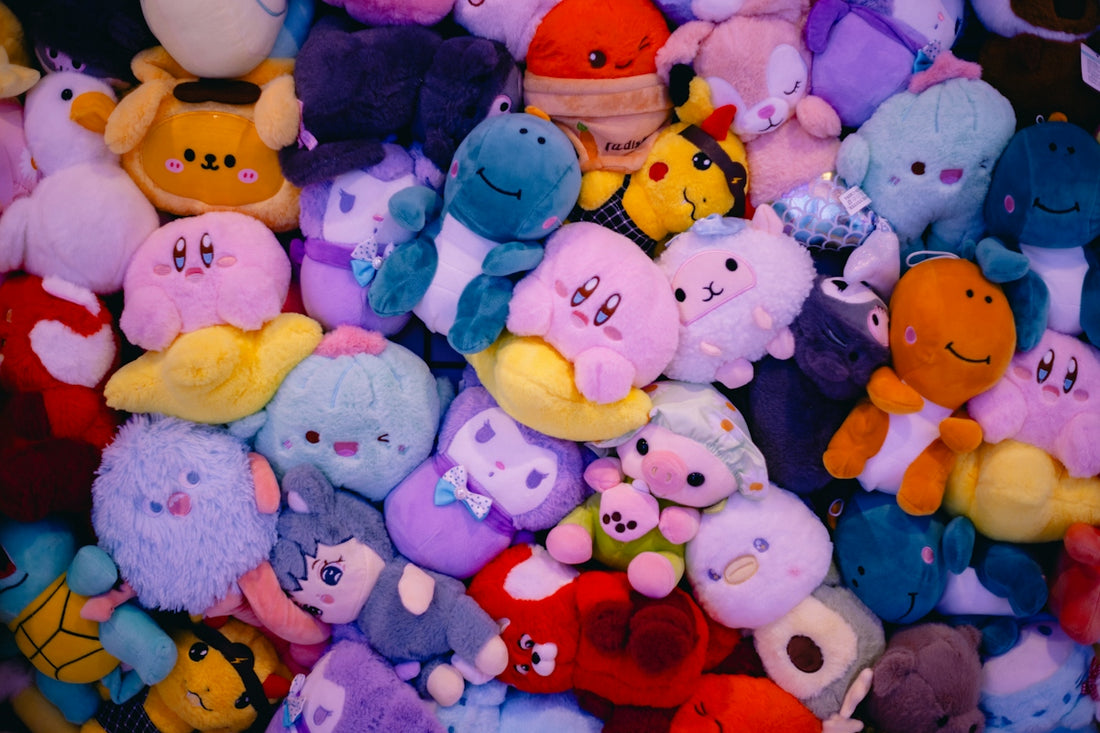 A pile of colorful plushies covers the frame